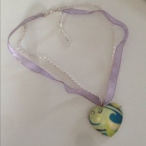 Necklace a Dangling Heart on a Ribboned Chain